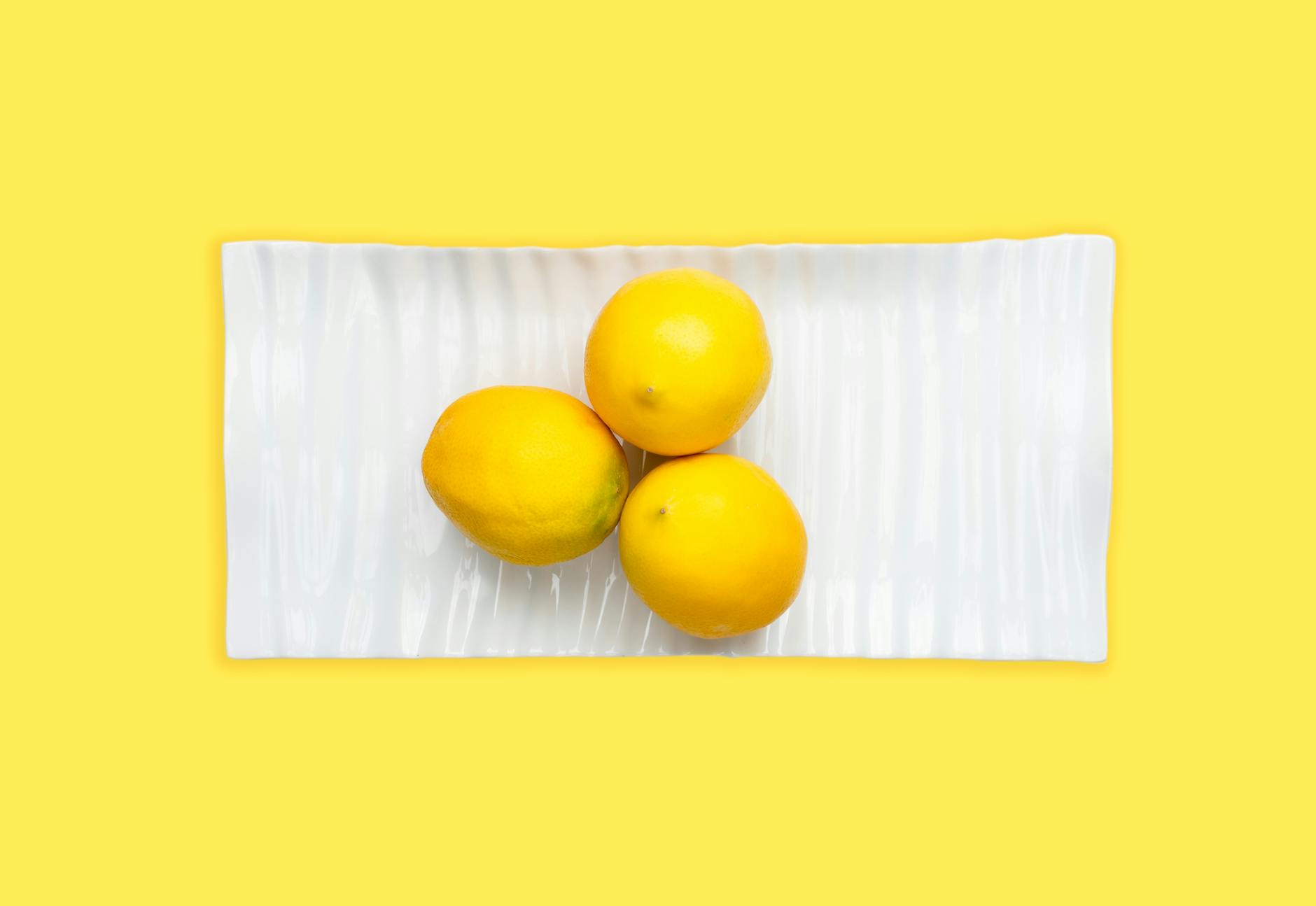 A person holding a fresh lemon, symbolizing freshness and new conversations about pleasure
