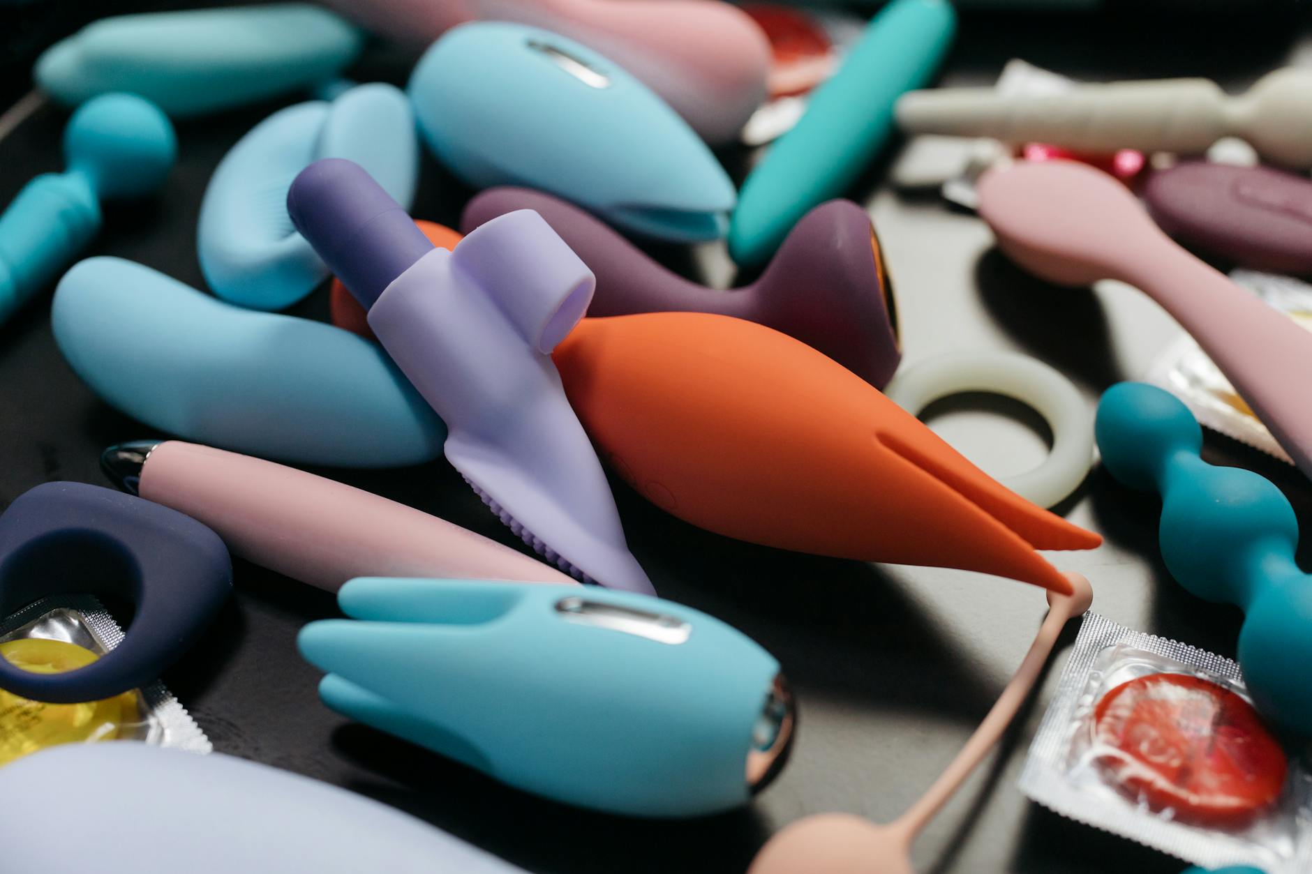 An array of vibrant adult toys including lemon clitoral vibrators and other intimate wellness products in a close-up view.