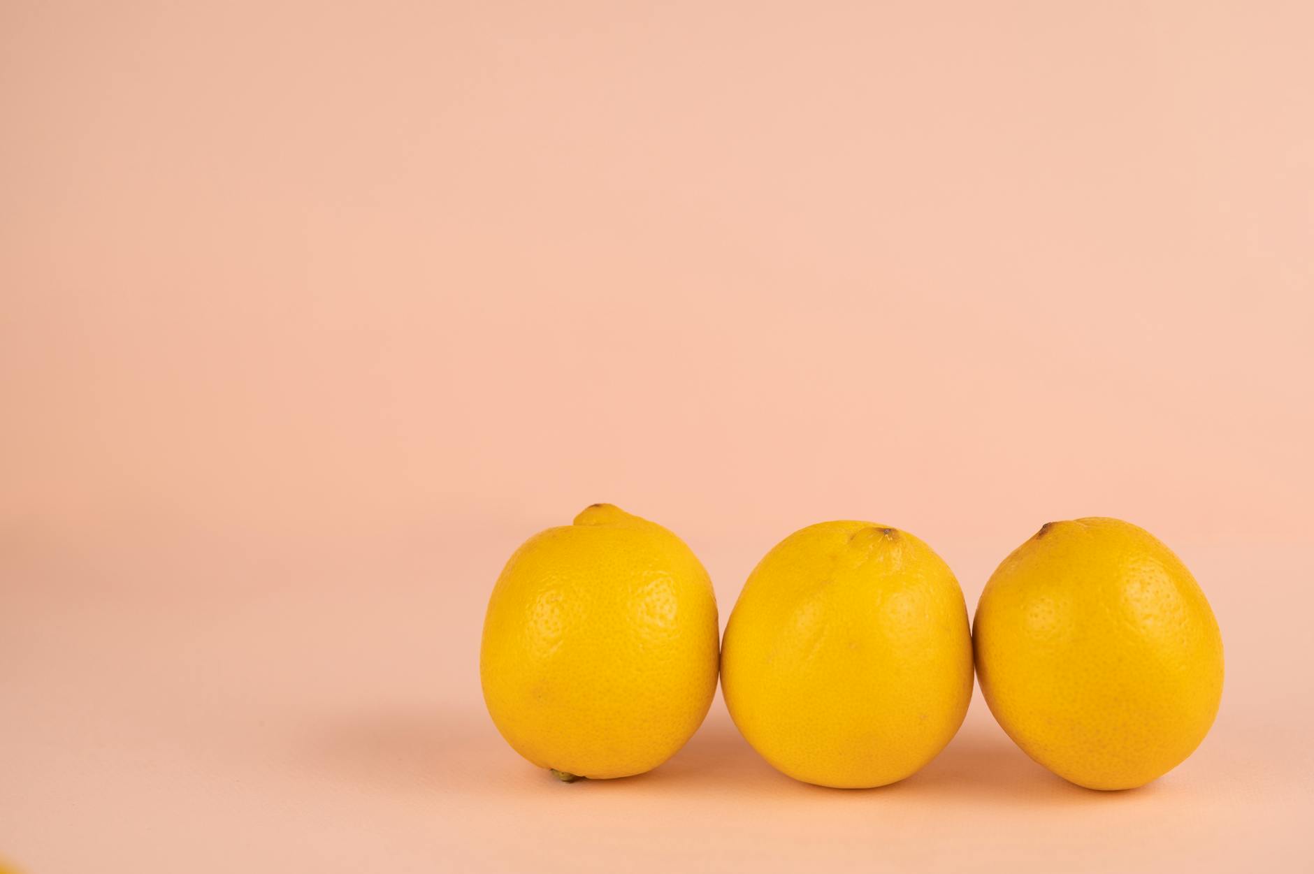 Bright ripe lemons on a pastel background, symbolizing fresh sensation and vitality